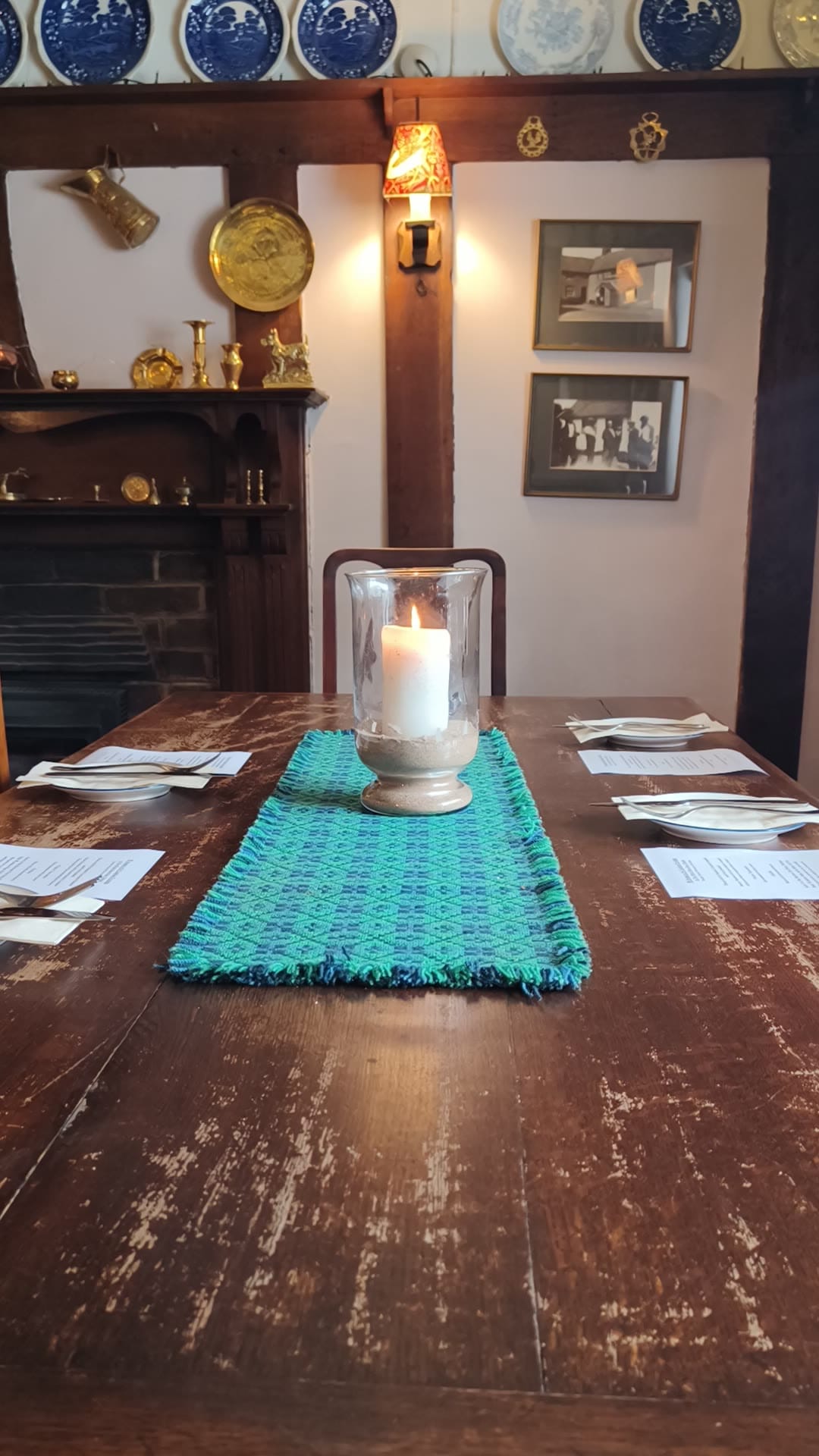Candlelit table in a cozy pub setting.