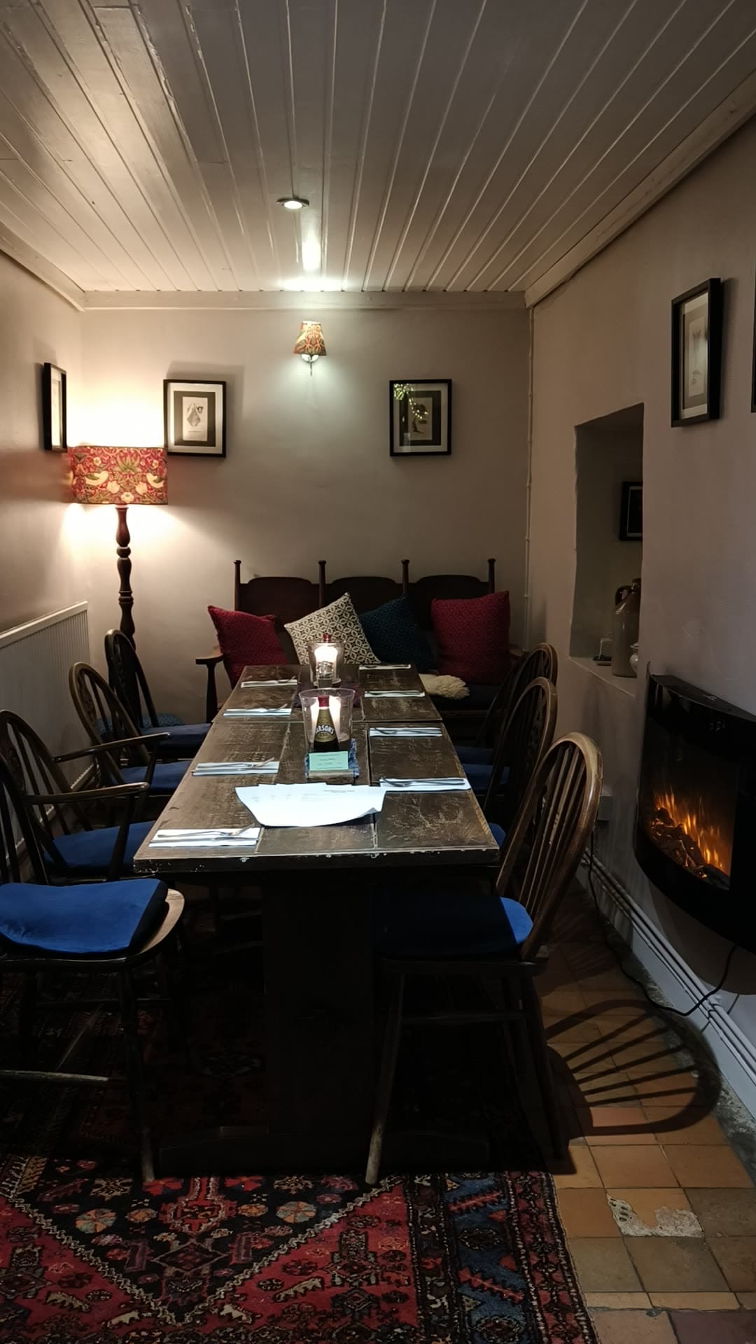 Cozy dining area with wooden table and chairs.
