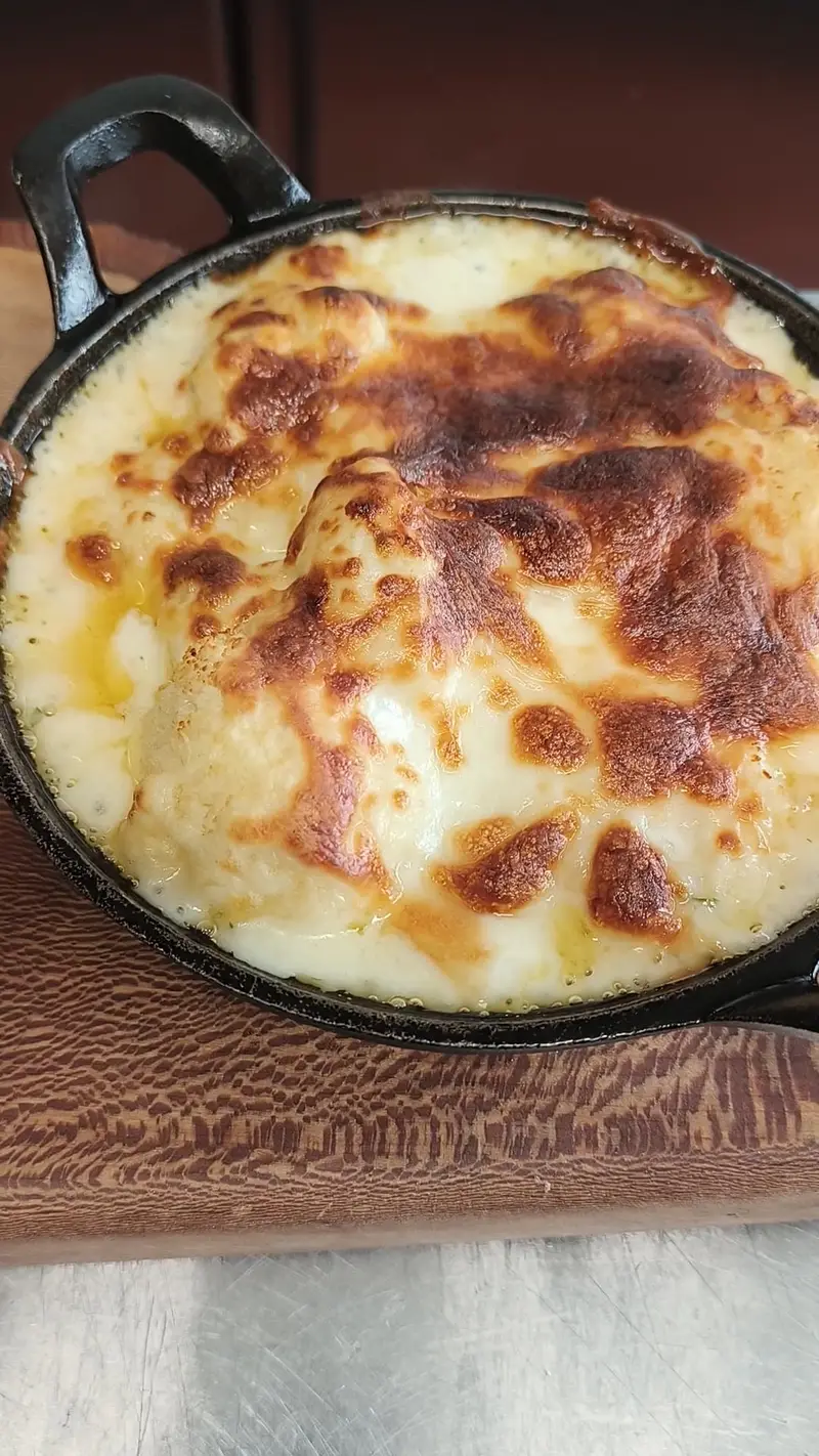 Baked dish with melted cheese in a skillet.