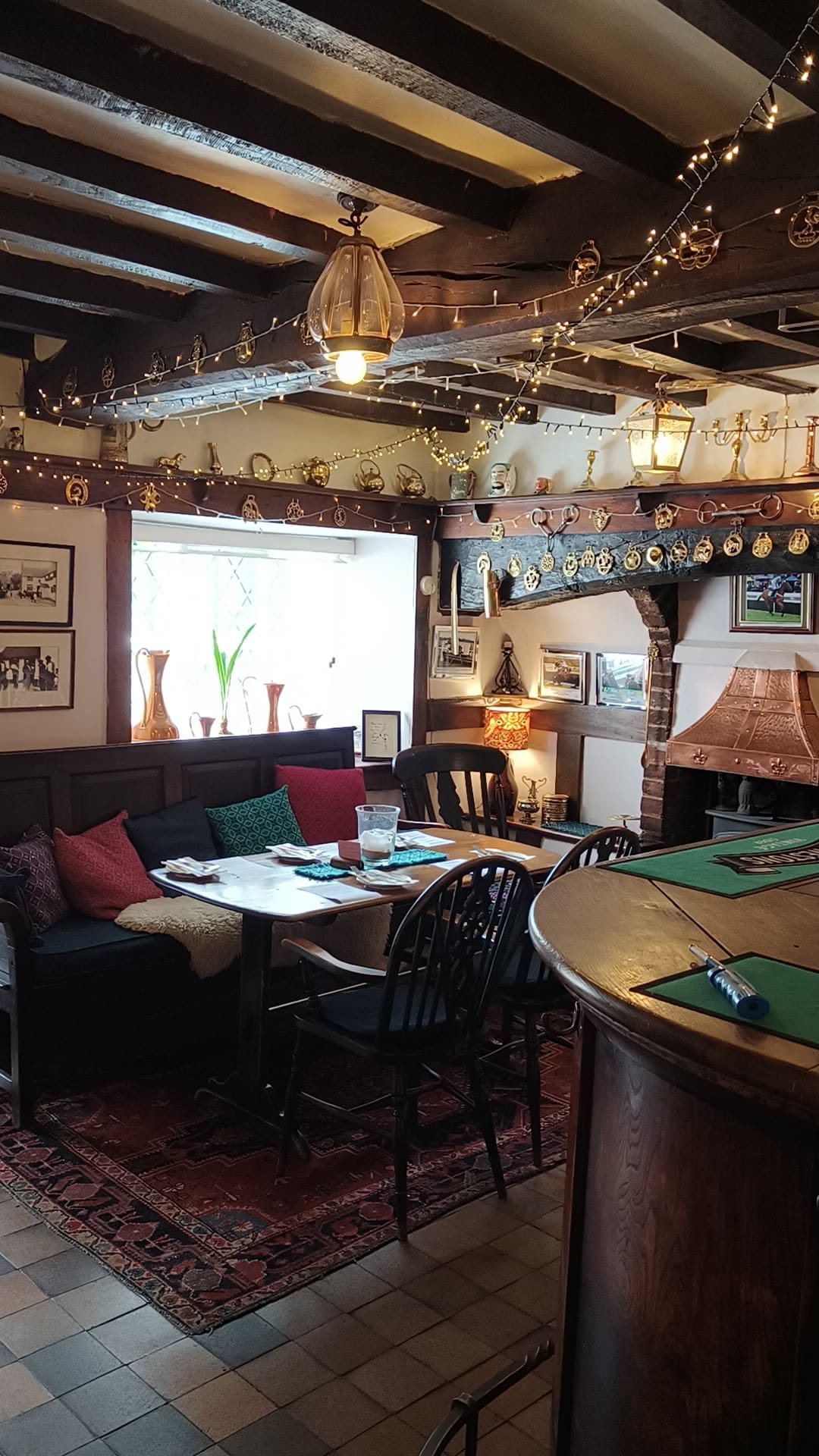 Cozy pub interior with rustic decor and seating area.