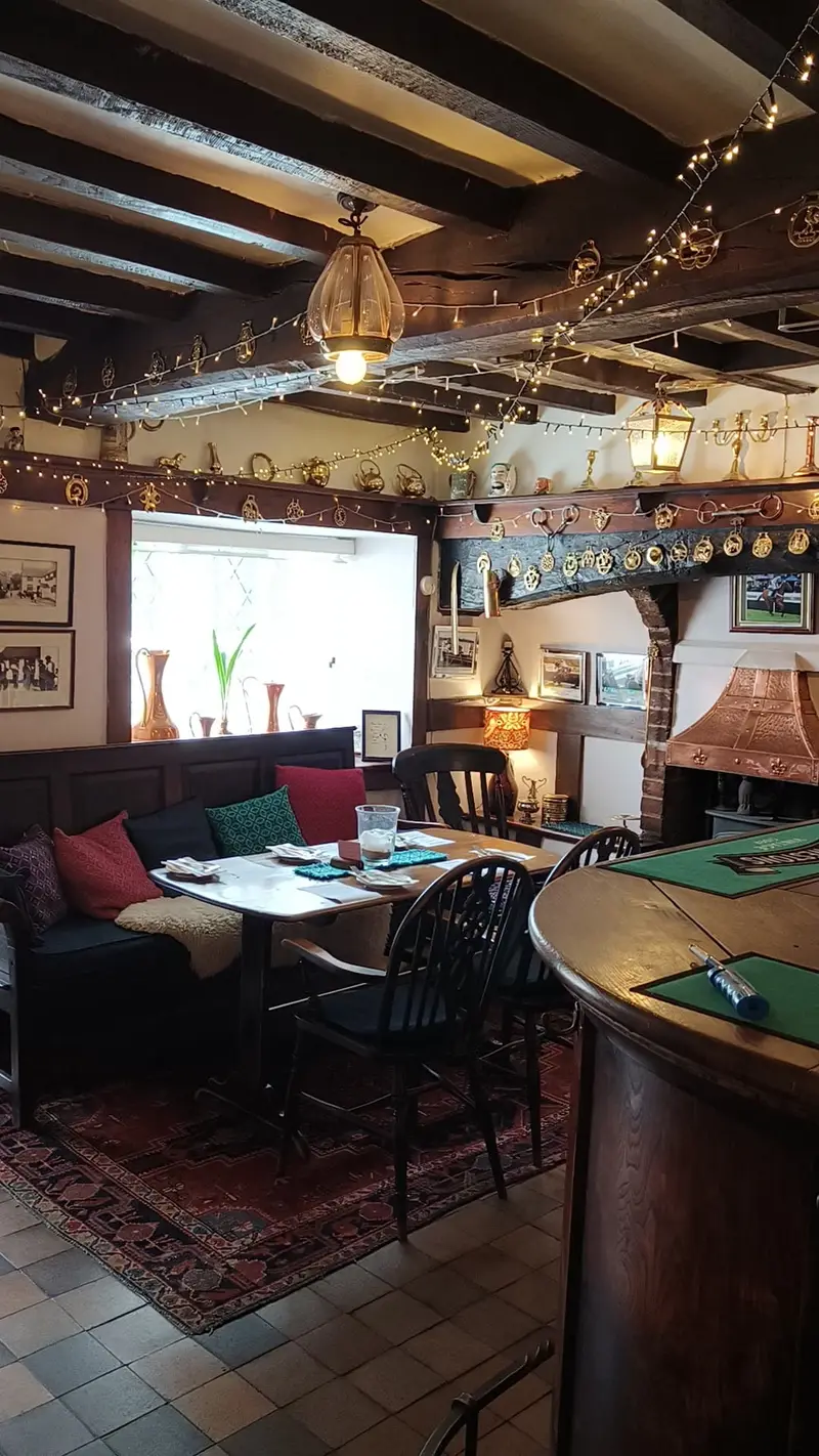 Cozy pub interior with rustic decor and seating area.